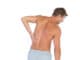 Man rubbing his back because of a back pain on white background