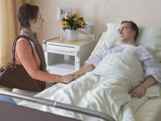 Side view of a women visiting men in hospital