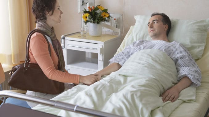 Side view of a women visiting men in hospital