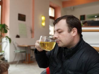 Man drinks green tea in a cafe
