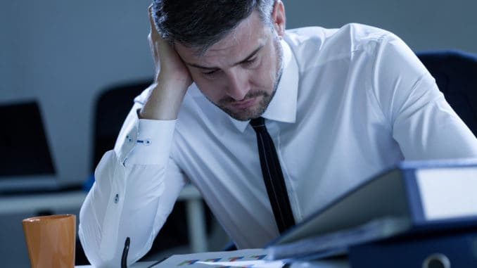 Tired man working late at the office