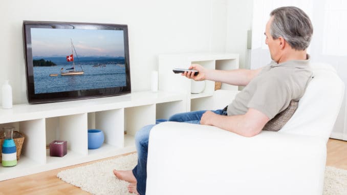 Portrait of a mature man watching tv at home