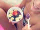 girl eating healthy food on beach