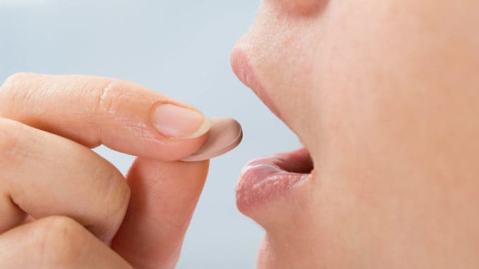 Person Taking Medicine Pill