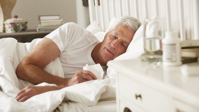 Sick Senior Man In Bed At Home