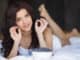 Beautiful young woman eating fresh summer blue berries and raspberry