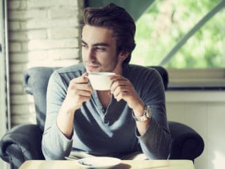 Young man drinking coffee in cafe