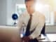 Young white business man working on computer sitting at his desk