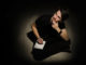 Teenager young man thinking and writing on notebook on black background