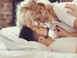 Lifestyle. Beautiful couple in bed