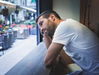 Man thinking by the bar window