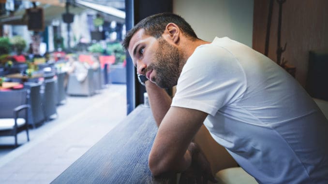 Man thinking by the bar window