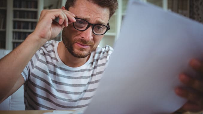 Worried man looking at his bills