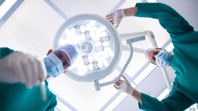 dreamstime_m_81429821 Surgeons operating in operation theater in hospital