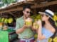 Couple Drink Coconut Asian Fruits Street Market Buying Fresh Food, Young Man And Woman Tourists Exotic Vacation Tropical Holiday