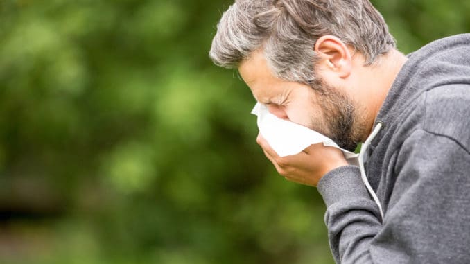 Man with allergy sneezing