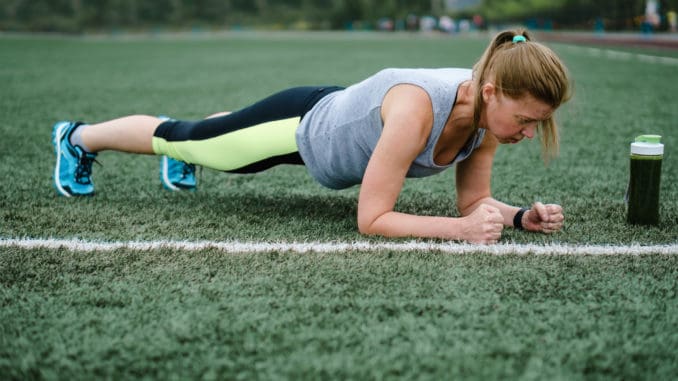 Woman training at the stadium. Physical activity and endurance. Physical Exercise