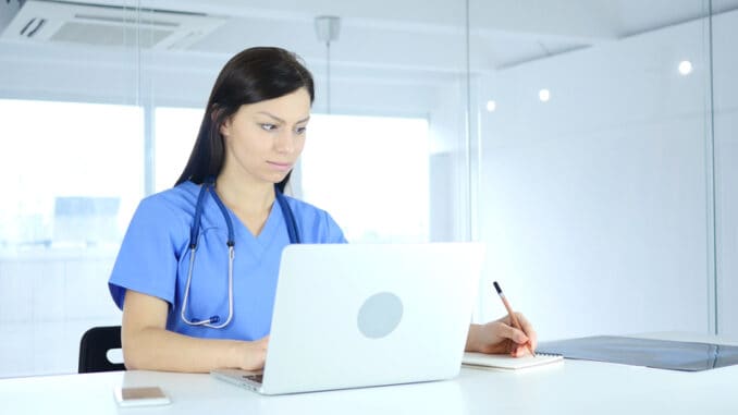 Doctor Writing Medical Reports of Patient