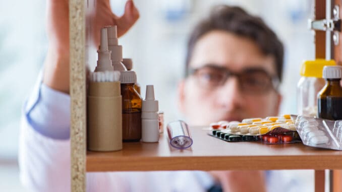 Doctor at farmacy retail shop looking for medicines