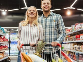 Cute couple grocery shopping together at the supermarket