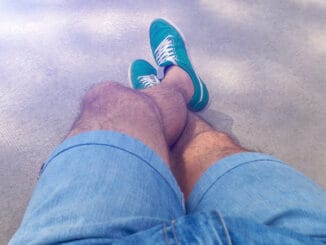 Man with hairy legs in denim shorts