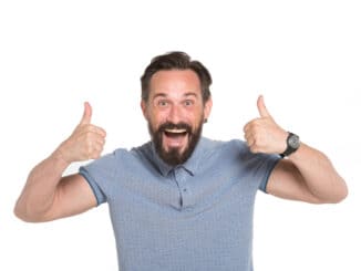 Emotional man with two thumbs up isolated on white background.