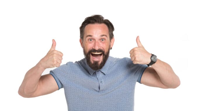 Emotional man with two thumbs up isolated on white background.