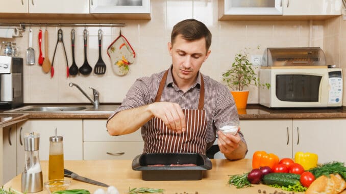 dreamstime_s_119472215 sprinkling meat seasoning