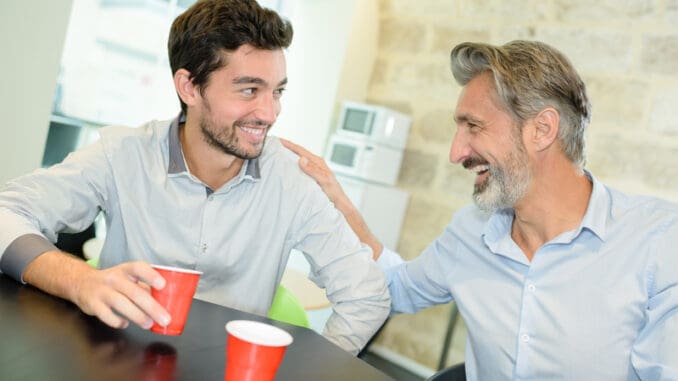 Men laughing and drinking coffee me