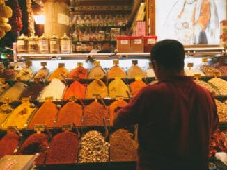 ear view of man choosing spices at market