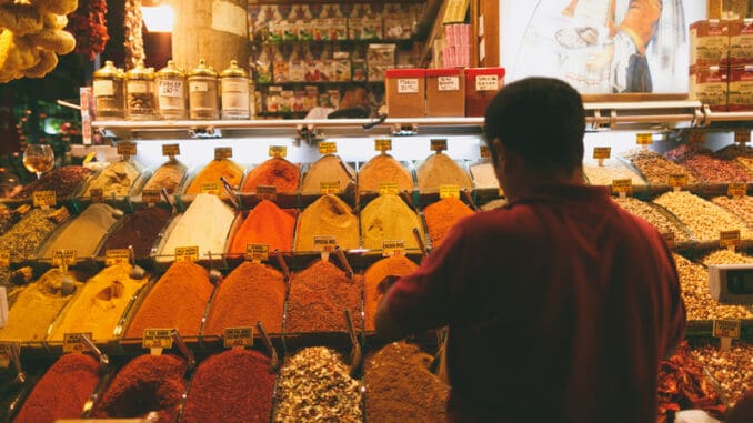 ear view of man choosing spices at market