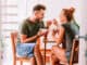 Young couple eating cereal breakfast at dining room table