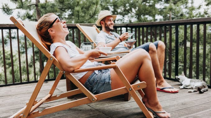 Couple enjoying coffee on a balcony in the mountains