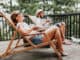 Couple enjoying coffee on a balcony in the mountains