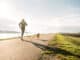 man jogging with his beagle dog