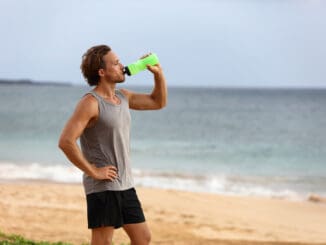 Fitness runner man drinking water