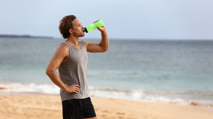 Fitness runner man drinking water