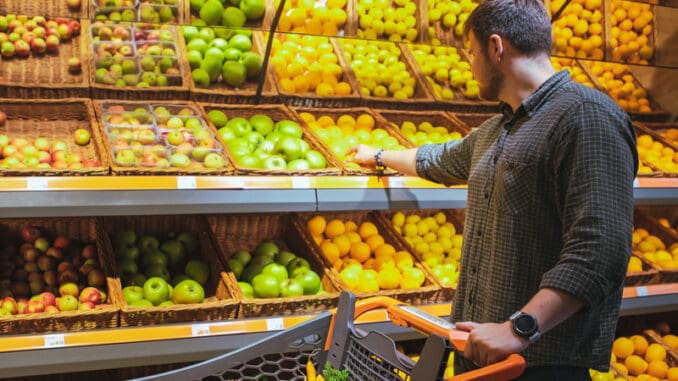 man in grocery store do shopping buying fruits copy space