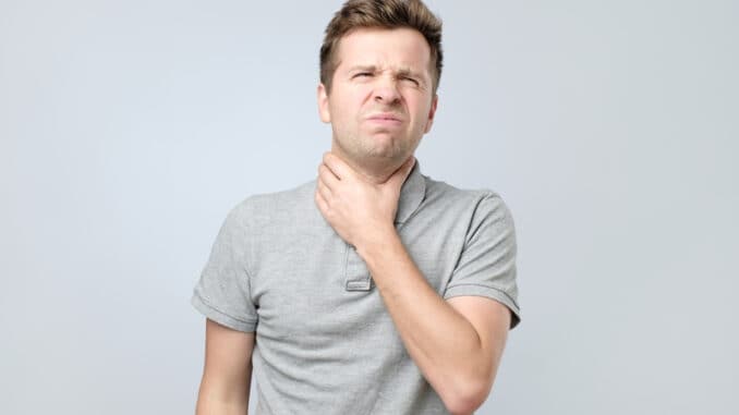 dreamstime_s_173867077 Young man with throat pain feeling ill.
