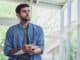 A man looking and thinking at note book while working at home office