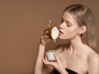 Beautiful young adult woman hold coconut in hand