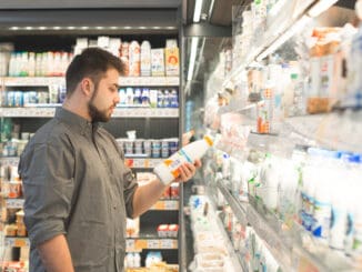 Man is in the milk department of a supermarket