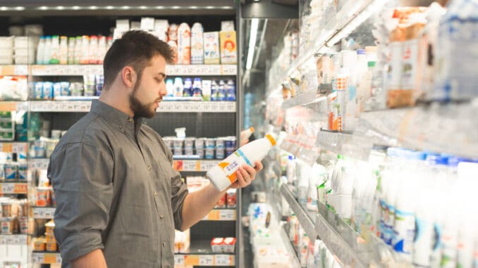 Man is in the milk department of a supermarket