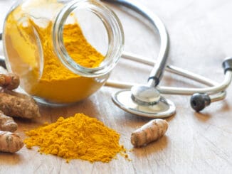 Turmeric powder and turmeric roots with stethoscope, natural medicine concept