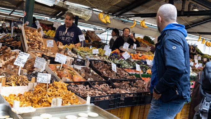 people selling and buying wild mushrooms