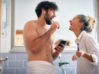 Sweet couple brushing teeth together in the morning