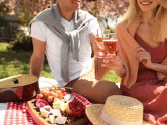 Happy couple having picnic in park on sunny day