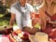 Happy couple having picnic in park on sunny day