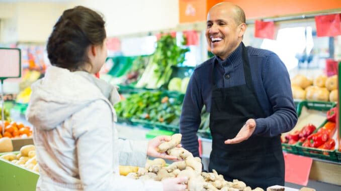 dreamstime_s_224919426 friendly salesman helping female customer to choose ginger in supermarket