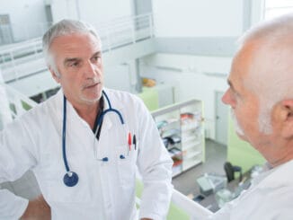 senior doctors talking on a bright stairway